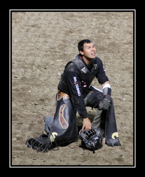 Cody Rodeo Cowboy kneeling in the arena