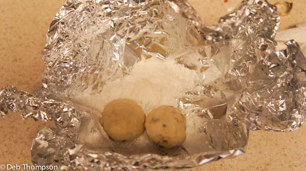Photo of Pecan Meltaways Christmas Cookies getting rolled in sugar.