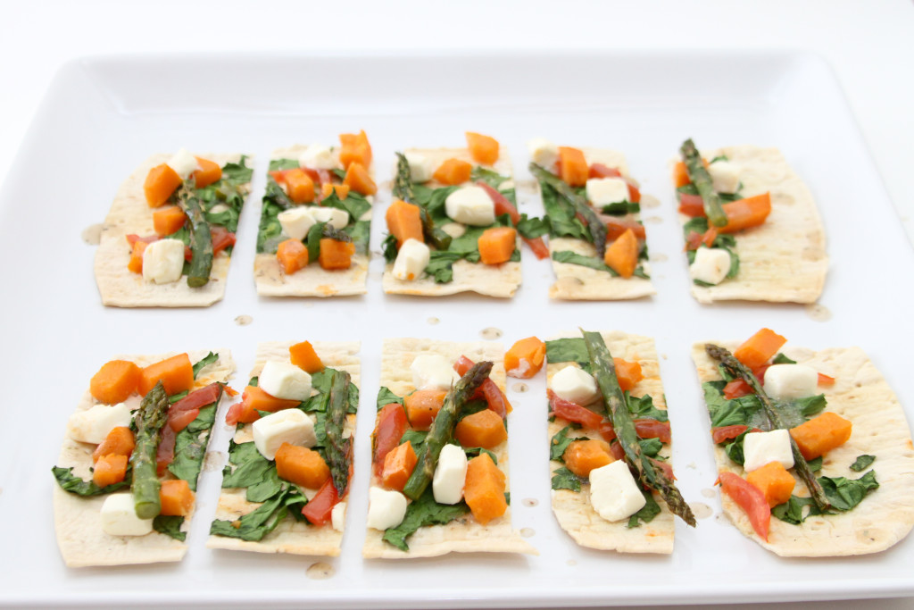 Farm Market Pizza topped with green and orange veggies.