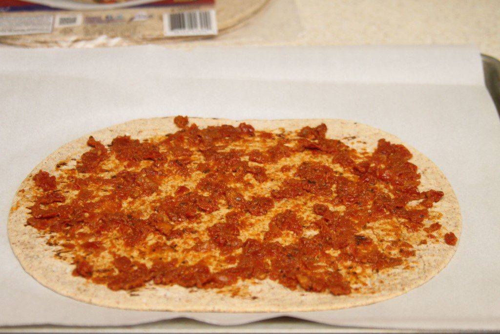 flatbread spread with sundried tomato pesto.