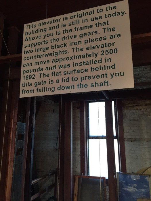 A sign informing guests that the elevator is original to the building & is still in use today inside Kaffie Frederick. The elevator can move approximately 2500 pounds & was installed in 1892.