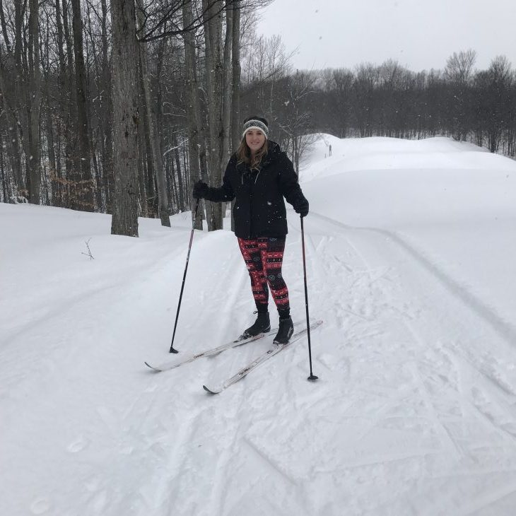 Photo of a women cross country skiing.