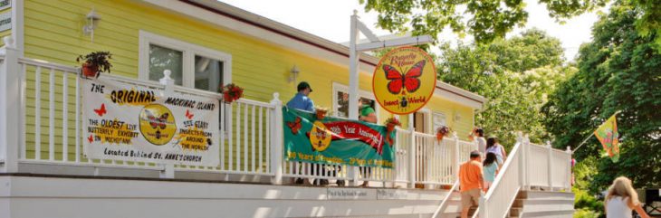 outside the butterfly house, a yellow one story building, on Mackinac Island