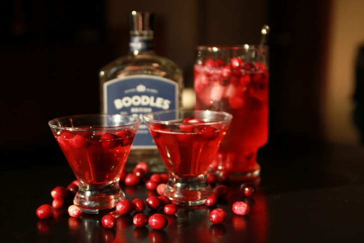 Photo of two cranberry cocktails and a bottle of Boodles Gin.