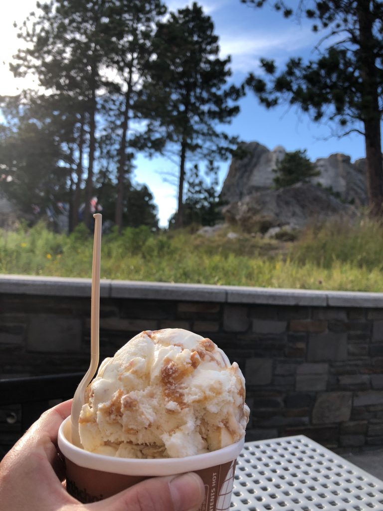 big scoop of ice cream in a dish, enjoyed at mount rushmore