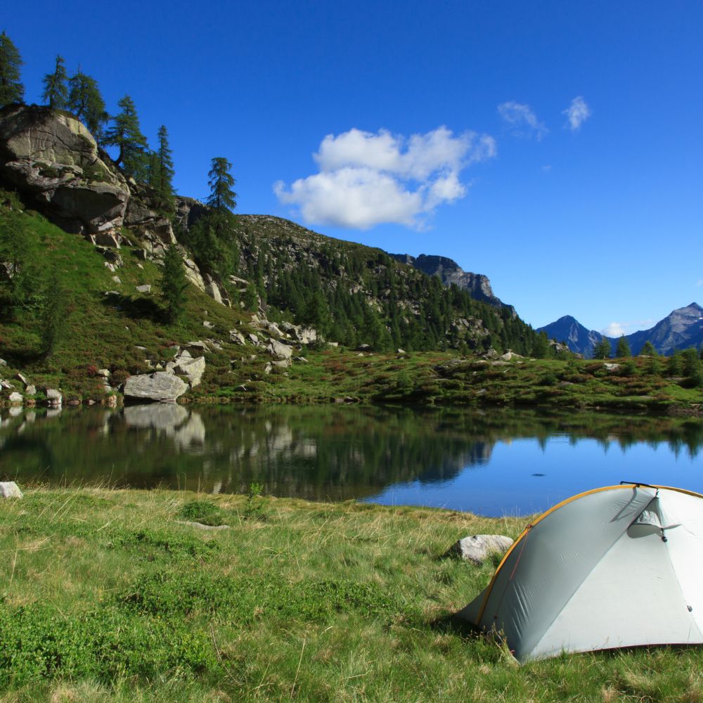 tent set up in view of crystal clear lake, best waterfront campsite.