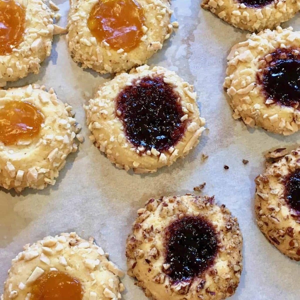 An array of thumbprint Cookies on a tray.