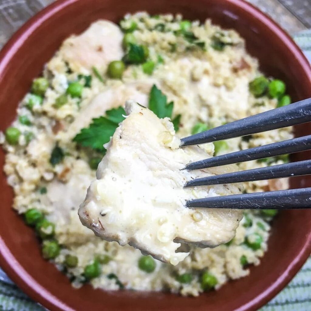 Chicken Quinoa and peas recipe with close up image of a piece of chicken.