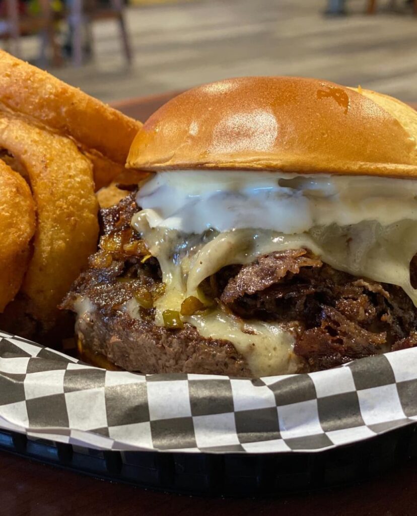 Delicious hamburger and onion rings at Crossroads Social.