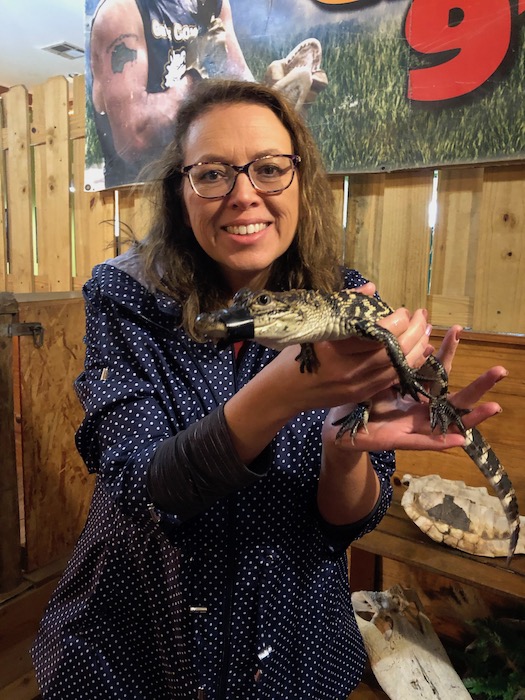 holding a baby gator at gator country in beaumont tx