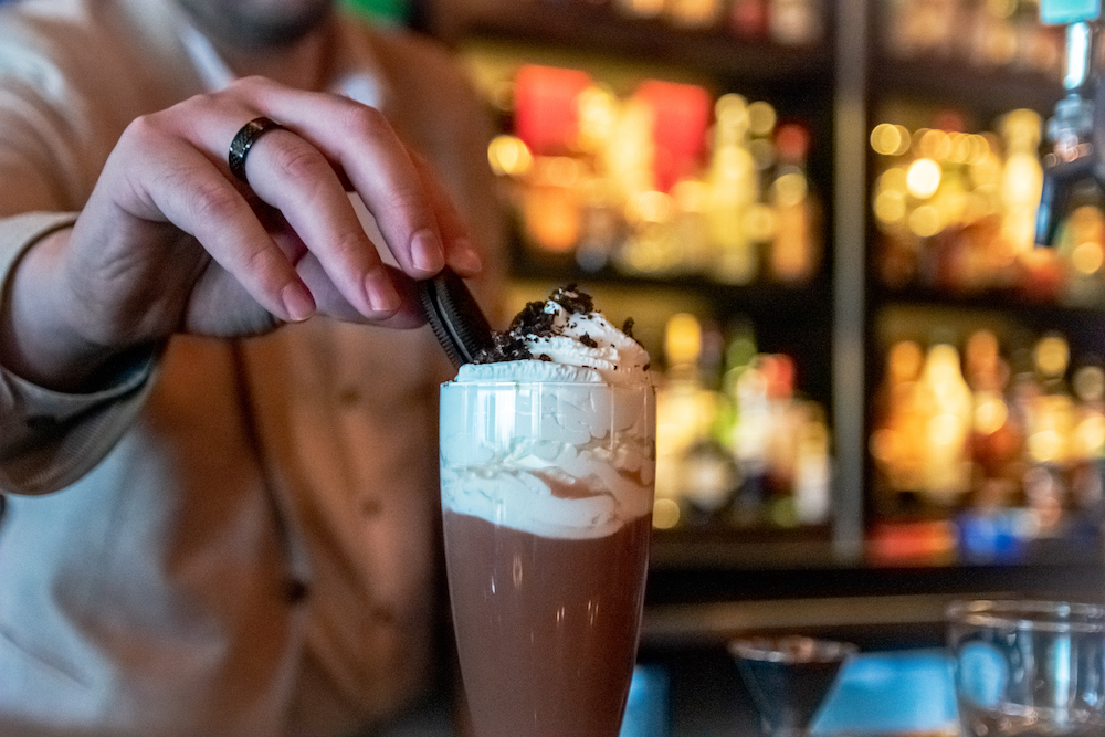 Hot Chocolate with whipped cream and an Oreo on the top.