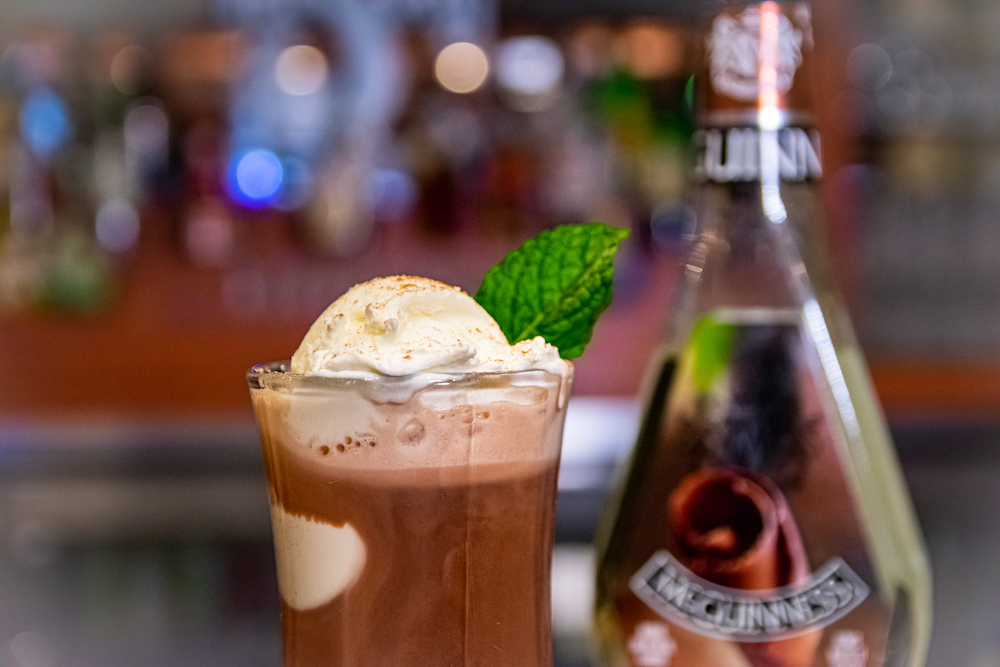 Hot Chocolate with whip cream and a mint leaf on top.