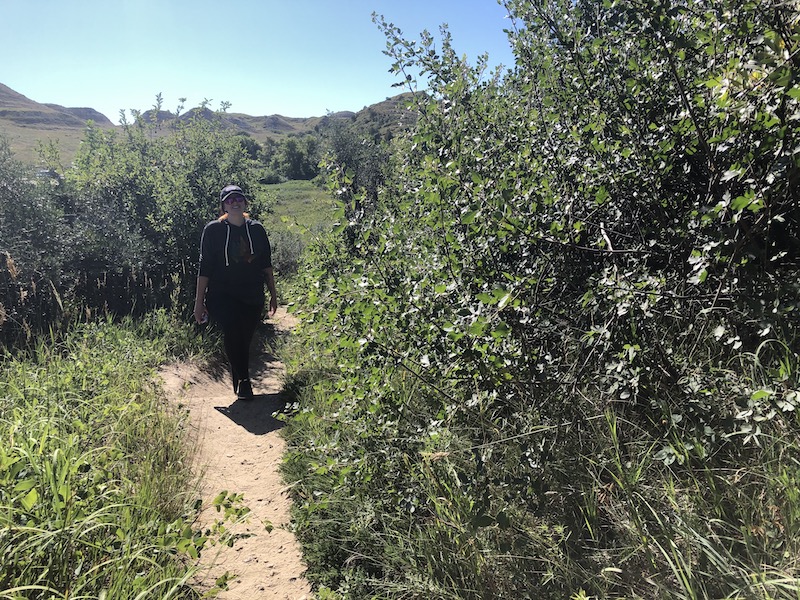 woman hiking a trail at wind canyon national park