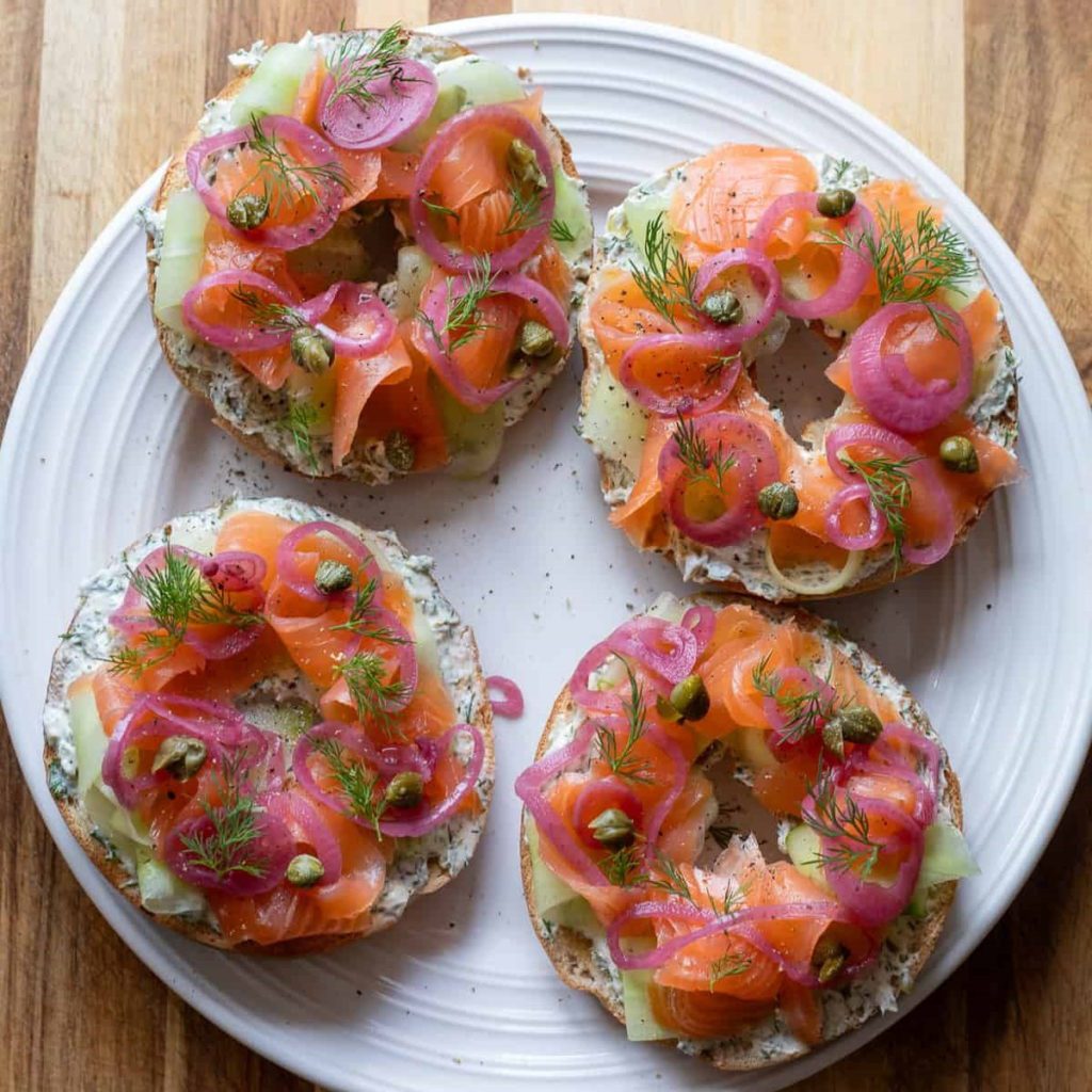4 Lox Bagels on a white plate.