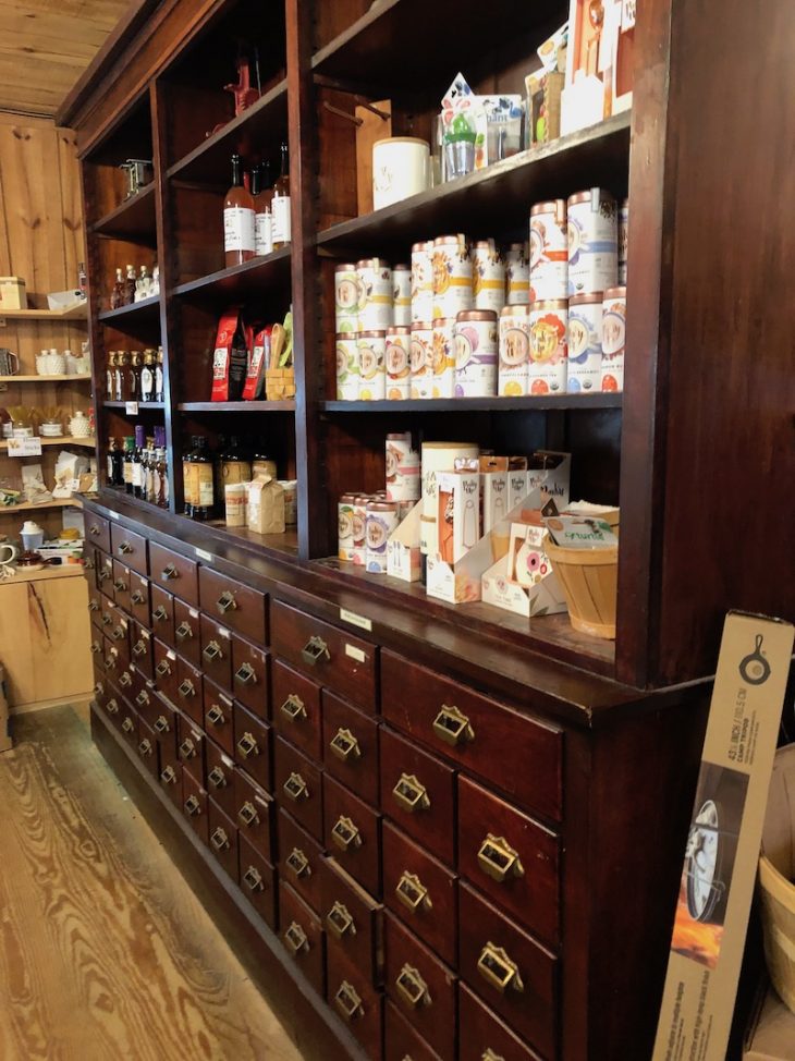 Photo of inside Nora Mills Granary. A shelving unit with products for sale.