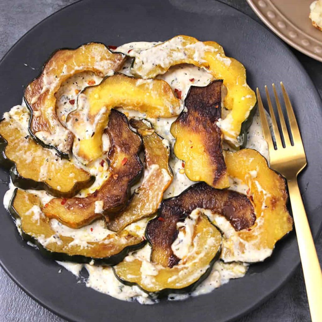 Roasted Acorn Squash Slices With Garlic Cream Sauce.