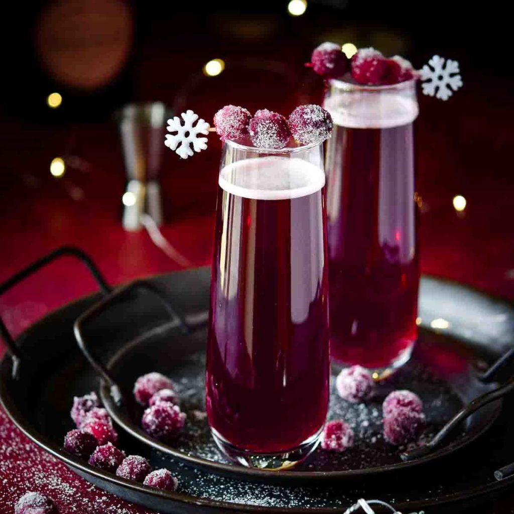 2 glasses of Sugared Cranberry Christmas Mimosas on a silver tray.