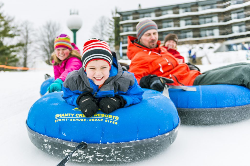 Photo of a family snow tubing. 