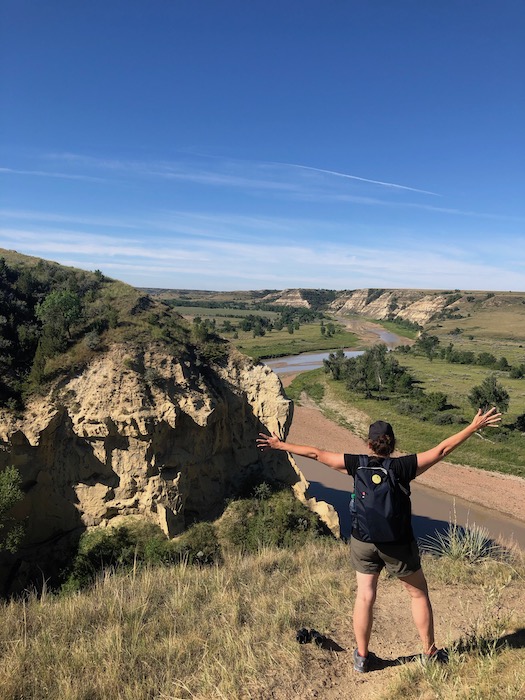 woman looking at the little missouri river on the wind canyon trail