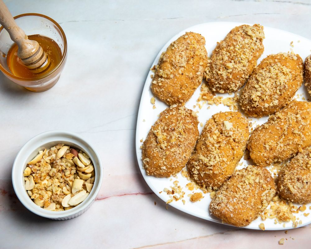 Photo of Greek Cookies (Honey drizzled over mountains of dough fritters with walnuts on top).