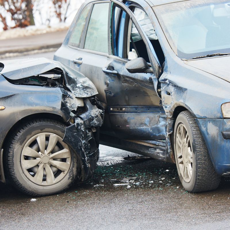 2 crumpled cars damaged from a car accident