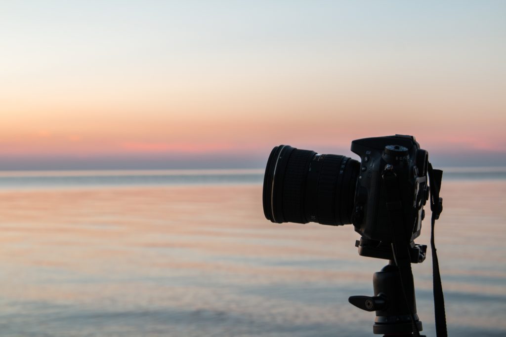Camera on tripod with sunset in background
