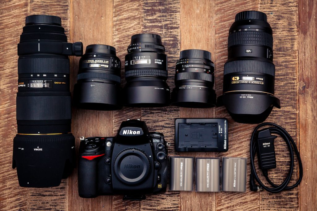 Camera, gear, and lenses on a table.