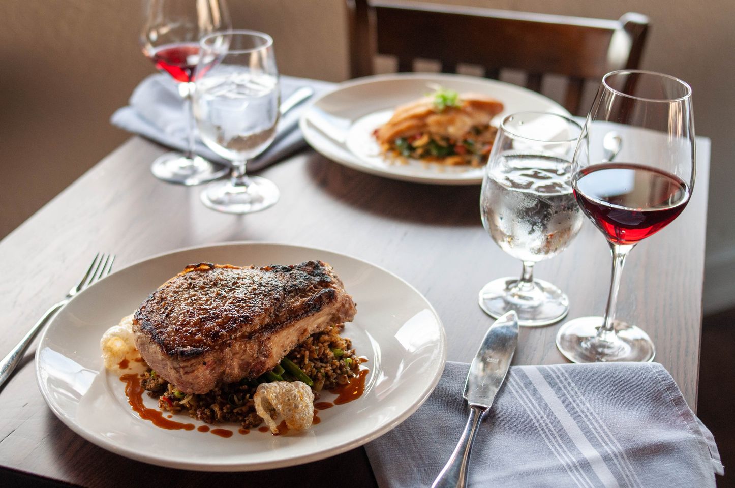 Meal for two with wine on wooden table at Terra Restaurant in Columbia, South Carolina.