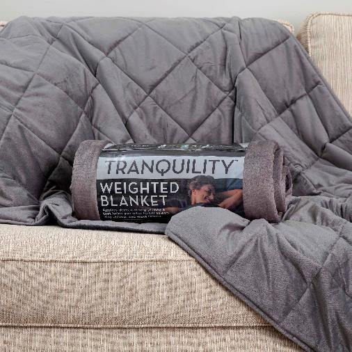 tranquility blanket spread over back of cream colored couch