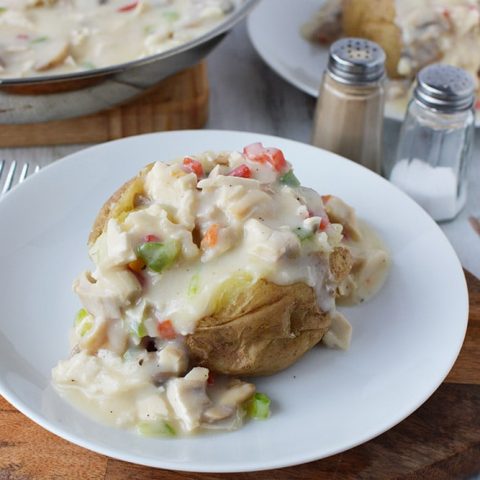 Photo of turkey a la king ( baked potato with turkey/gravy over top with some veggies).