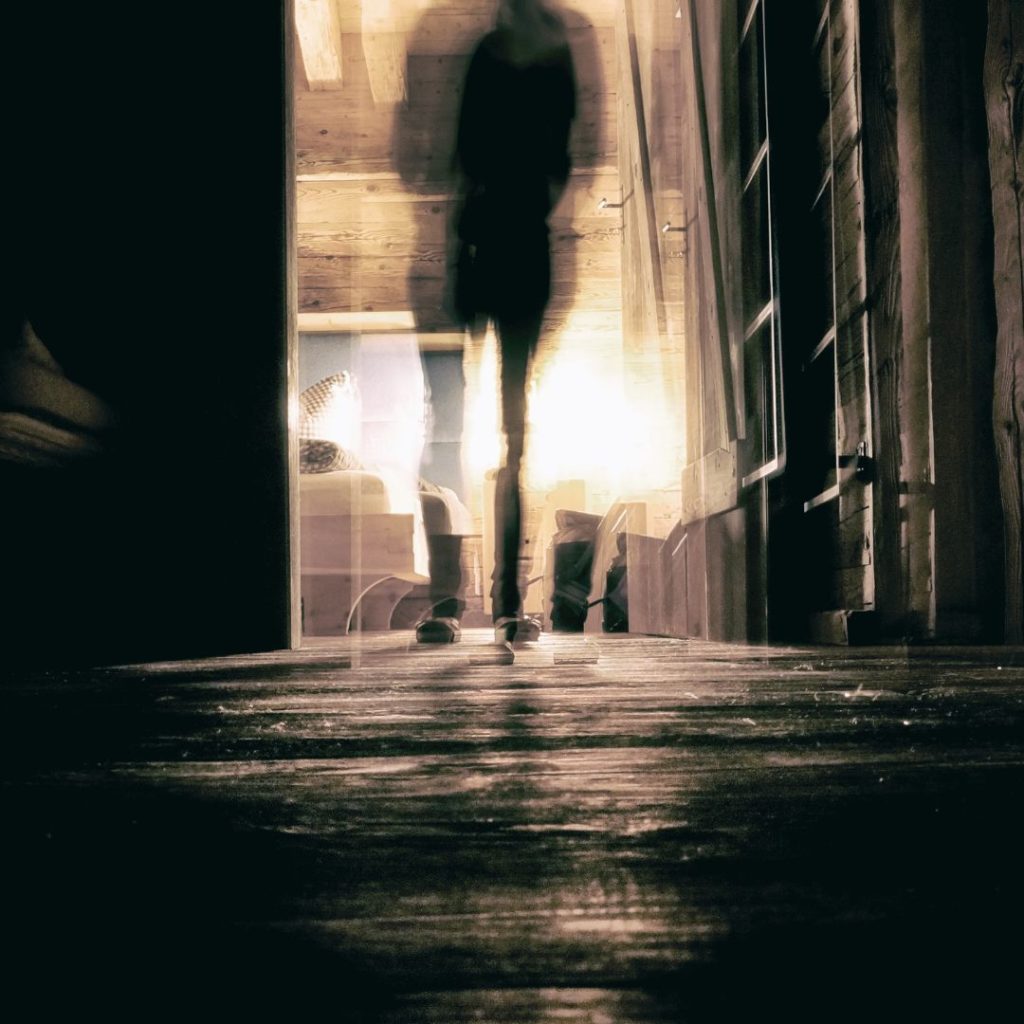 dark figure walking down shadowed hallway - WV ghost tours