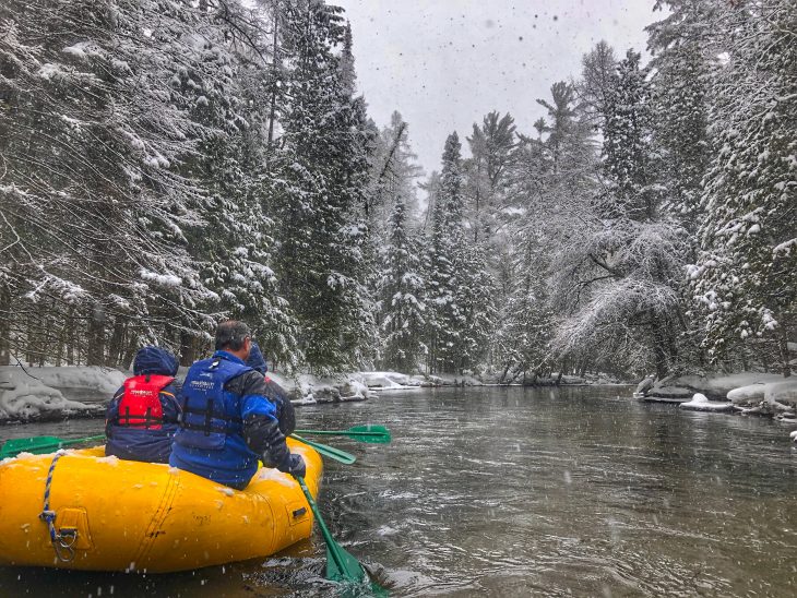 Rafting down the river in winter.